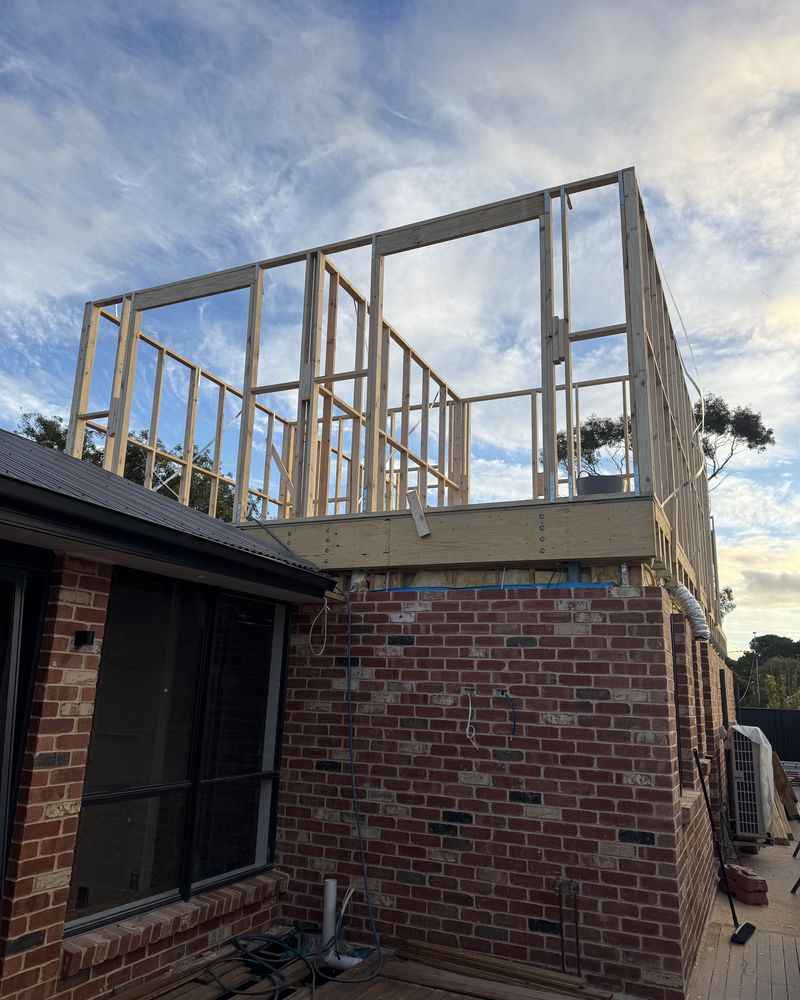 New timber wall frames for an upper level, standing over the original red brick